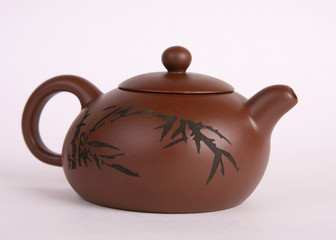 brown old isolated clay teapot on white background with hieroglyphs