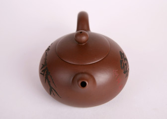 brown old isolated clay teapot on white background with hieroglyphs