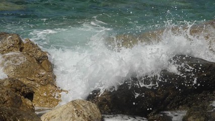 Sea waves crashing on stone beach. Slow motion sea waves crashing. 