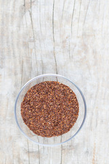 Loose tea rooibos superior in a glass cup on a wooden background
