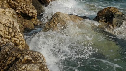 Sea waves crashing on stone beach. Slow motion sea waves crashing. 