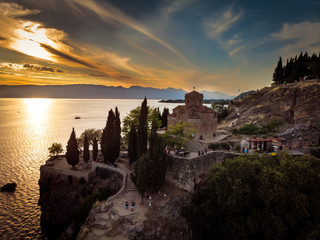 Church of St. John the Theologian  over Kaneo Beach by the Ohrid lake in North Macedonia. Aerial view in sunset.