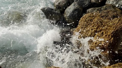 Sea waves crashing on stone beach. Slow motion sea waves crashing. 