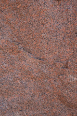 The structure of red and black granite. The texture of natural stone. Creative vintage background.