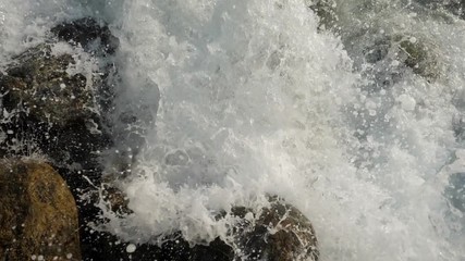 Sea waves crashing on stone beach. Slow motion sea waves crashing. 