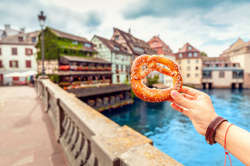delicious pretzel at the background of Strasbourg city landscape - obrazy, fototapety, plakaty