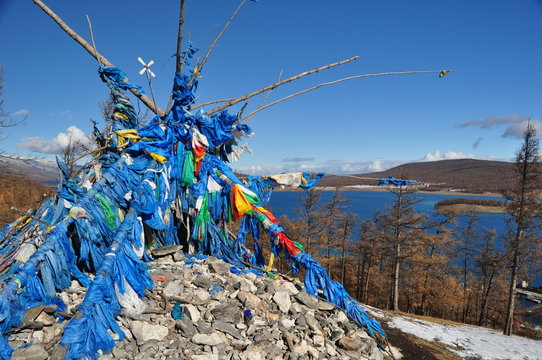 An ovoo (Mongolian sacred stone heap) over Lake Khuvsgul, Mongolia