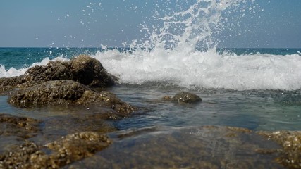 Sea waves crashing on stone beach. Slow motion sea waves crashing. 