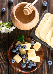 cheese with blueberries on a wooden background