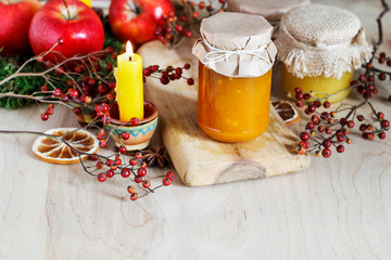 Fototapeta na wymiar Jar of jam and jar of honey among autumn fruits and plants.