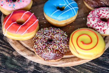 Glazed donuts on wooden background