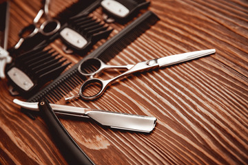 Fototapeta premium Hairdresser barber shop tools on old wooden background, copy space