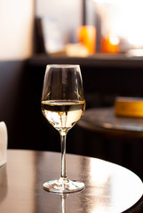 Glass of wine on the wooden in a bar. Close up 