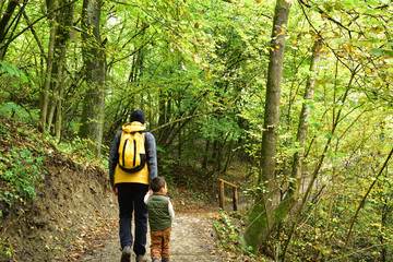 Boy traveling with his father in Slovenia, in the fall