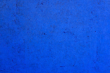 The structure of concrete is blue. Creative vintage background. Structural plaster. Modern lights in the form of a white ball on a long wire.