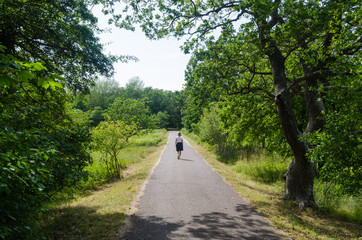 Woman on a relaxing summer walk in a green park