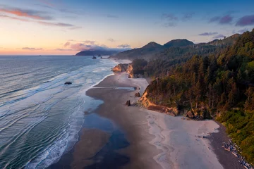  Aerial View of Arch Cape, Oregon. Sunset along the Oregon coast near Cannon Beach features white sand beaches with fir and cedar forests as far as the eye can see.  © LoweStock
