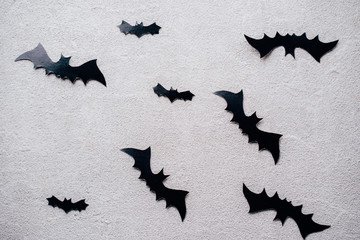 Halloween holiday concept. Funny paper bats decorations on stone background. Party invitation mockup, celebration. Flat lay, top view, copy space