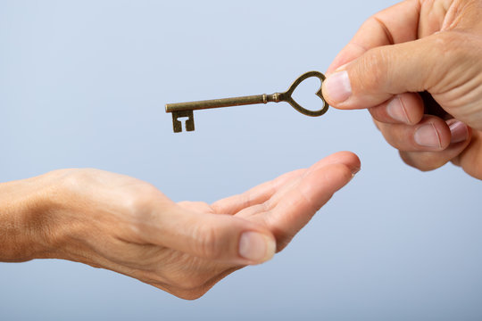 Person Hand Giving Home Key To A Client