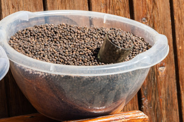 Basin of black peppercorns