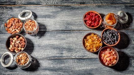 Mix of nuts and dried fruits on dark background. Healthy food and snack. Top view whith copy space