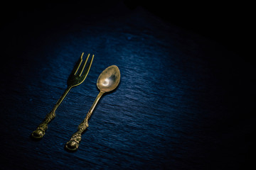 Beautiful dessert spoons on black background