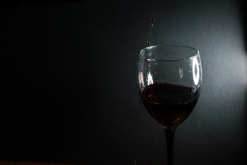 Red wine is poured into a glass