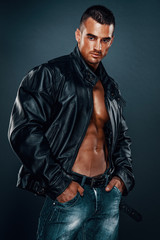 Obraz premium Handsome Athletic Male Model Wearing Leather Jacket on Naked Torso