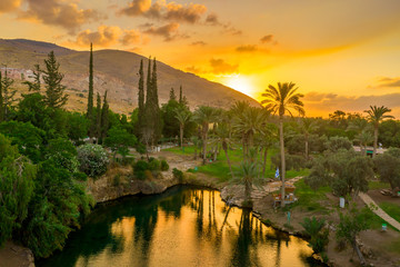 Aerial view of the sunset over Sachne or Gan Hashlosha oasis, with popular waterfall in Northern Israel