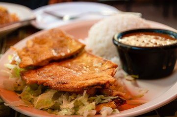 Steak Jibarito sandwich with white rice and beans on the side. Urban Puerto Rican food cuisine.