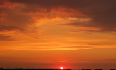 Beautiful fiery orange sunset view over the city, natural background