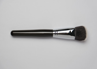 Cosmetics brush n the white table