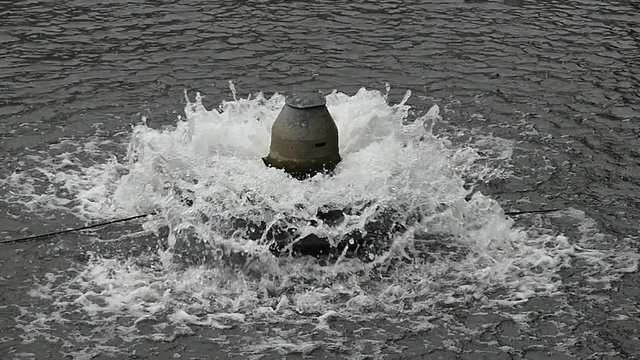 A small fountain in the park.Spray of water in the fountain.