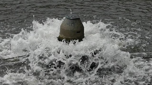 A small fountain in the park.Spray of water in the fountain.
