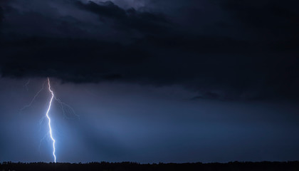 Beautiful landscape with s thunder. Blue sky with a thunderstorm. Storm at night. © nick_fedirko