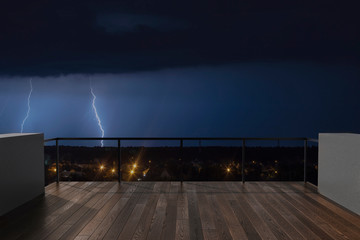Thunderstorm on the balcony. Balcony view of  sky with thunder. Landscape. Night. Terrace with a beautiful view of storm. Background with beautiful landscape.