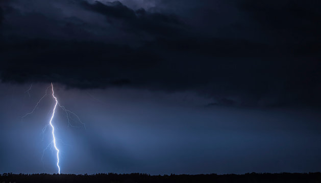 Beautiful landscape with s thunder. Blue sky with a thunderstorm. Storm at night.