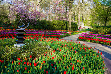 Keukenhof, Lisse, Netherlands - 18 April 2019: The view of different corners of the Keukenhof park, sun-clock, sun dial, the worlds largest flower and tulip garden park in Holland.