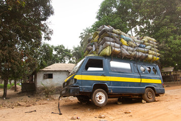 Old and overloaded transport with goods on its roof and inside
