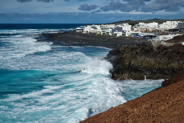 LANZAROTE, SPAIN, El Golfo, The Gulf is a lagoon in a volcanic crater surrounded by steep cliffs, nice day but rough sea