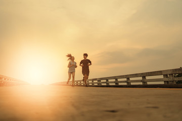 Fototapeta premium Women and men jogging in the evening for good health