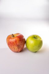 Fuji and green granny smith apples isolated against a white background