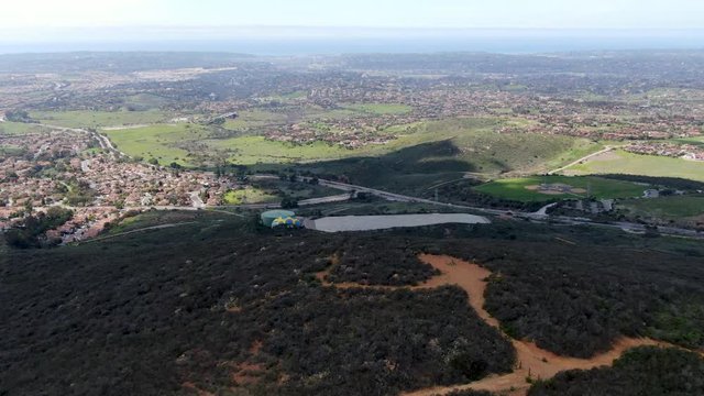 Para-glider over the top of the mountain during summer sunny day. Para-glider on the para-plane, strops -soaring flight moment flying over Black Mountain in San Diego, California. USA