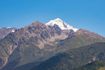 Naklejka premium Mount Tetnuldi rises above the Great Caucasian Range in the upper Svaneti in Georgia, Mountain Landscape.