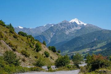 Fototapeta na wymiar Mount Tetnuldi rises above the Great Caucasian Range in the upper Svaneti in Georgia, Mountain Landscape.
