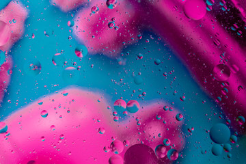 Micro molecular abstract pattern of colored oil bubbles on water. 