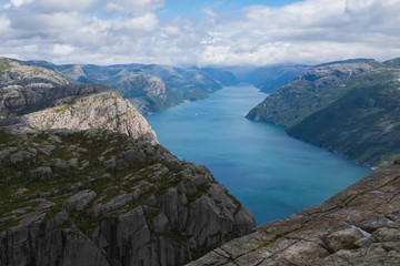 Fototapeta na wymiar Preikestolen massive cliff (Norway, Lysefjorden summer morning view). Beautiful natural vacation hiking walking travel to nature destinations concept. July 2019