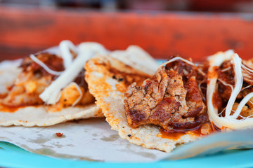 Delicious tacos of steak with cheese and spicy chili sauce, traditional Mexican street food dish.