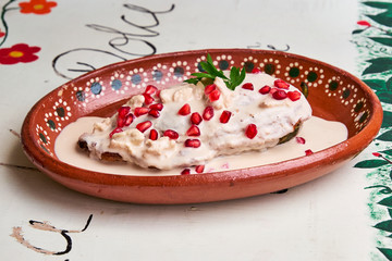 Chile en Nogada, a traditional dish from Puebla with the addition of walnut cream, pomegranate seeds and parsley.