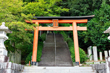 A torii, a gateway to Shiota hachiman-gu shrine in Kobe, Hyogo, Japan.  Translation; Japanese characters in the plate put on the gate means "Hachiman shrine".